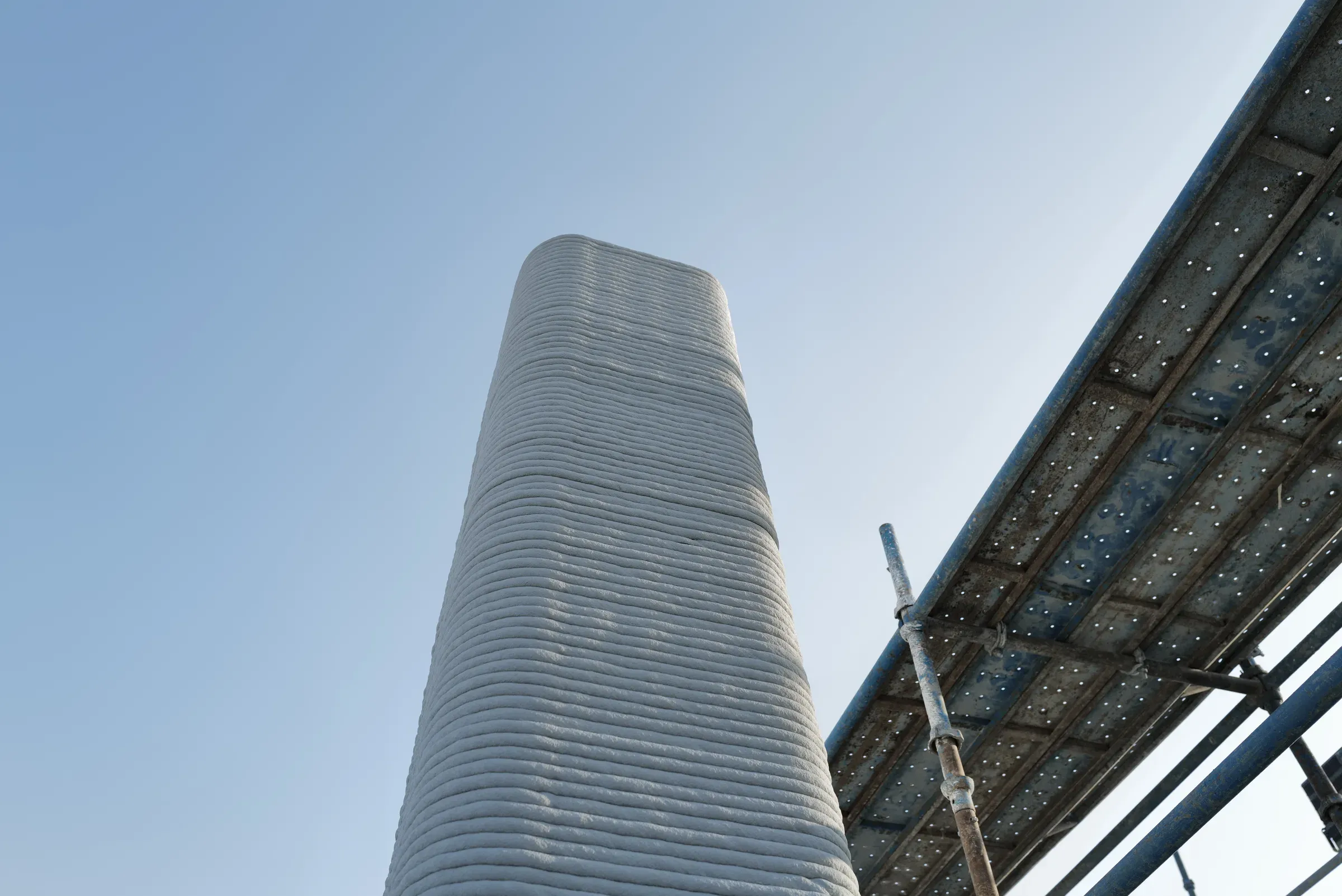 Printed concrete column against the sky, School 08, Doha