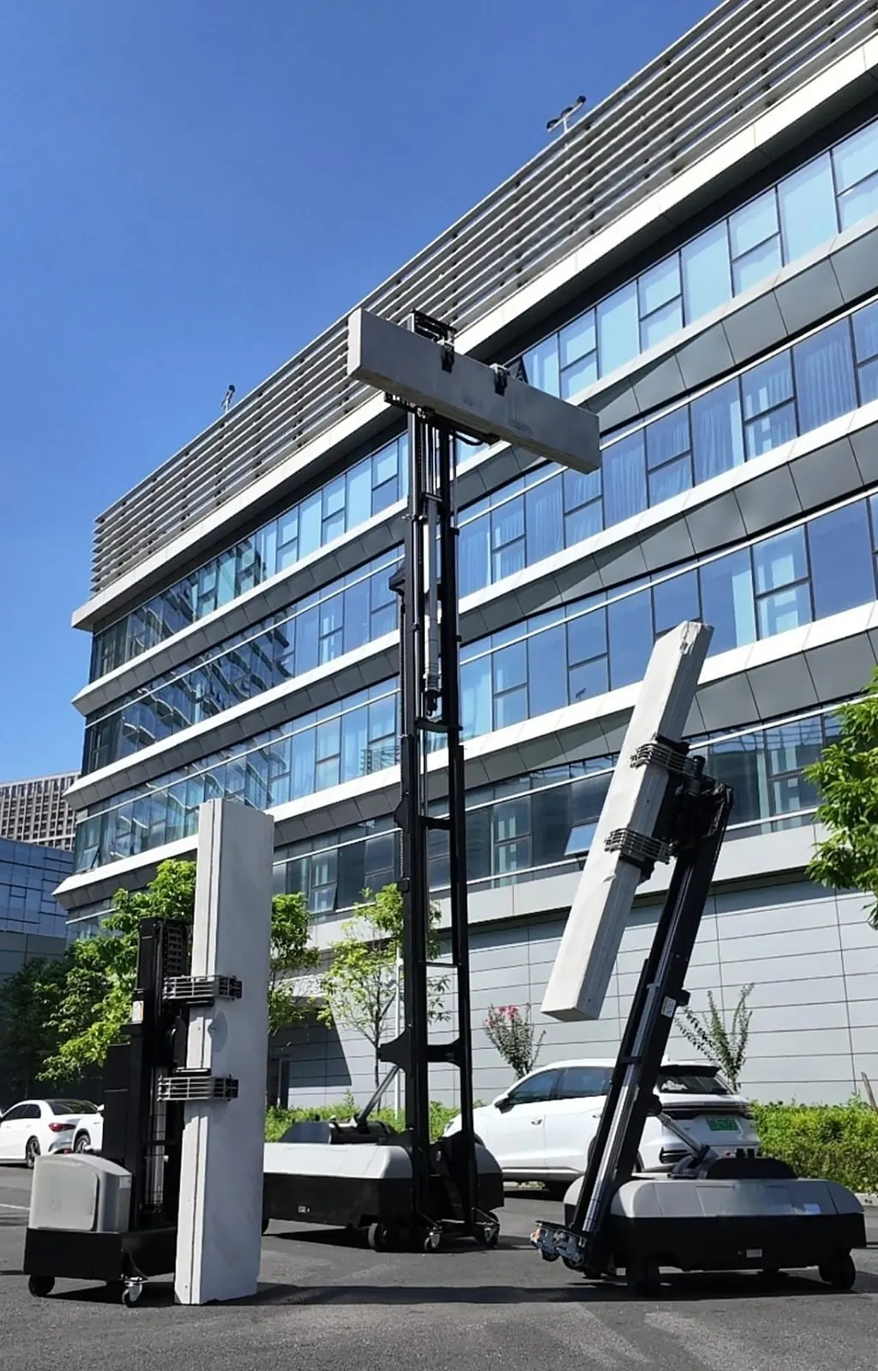 Panel robots standing tall AAC panels beside an office building