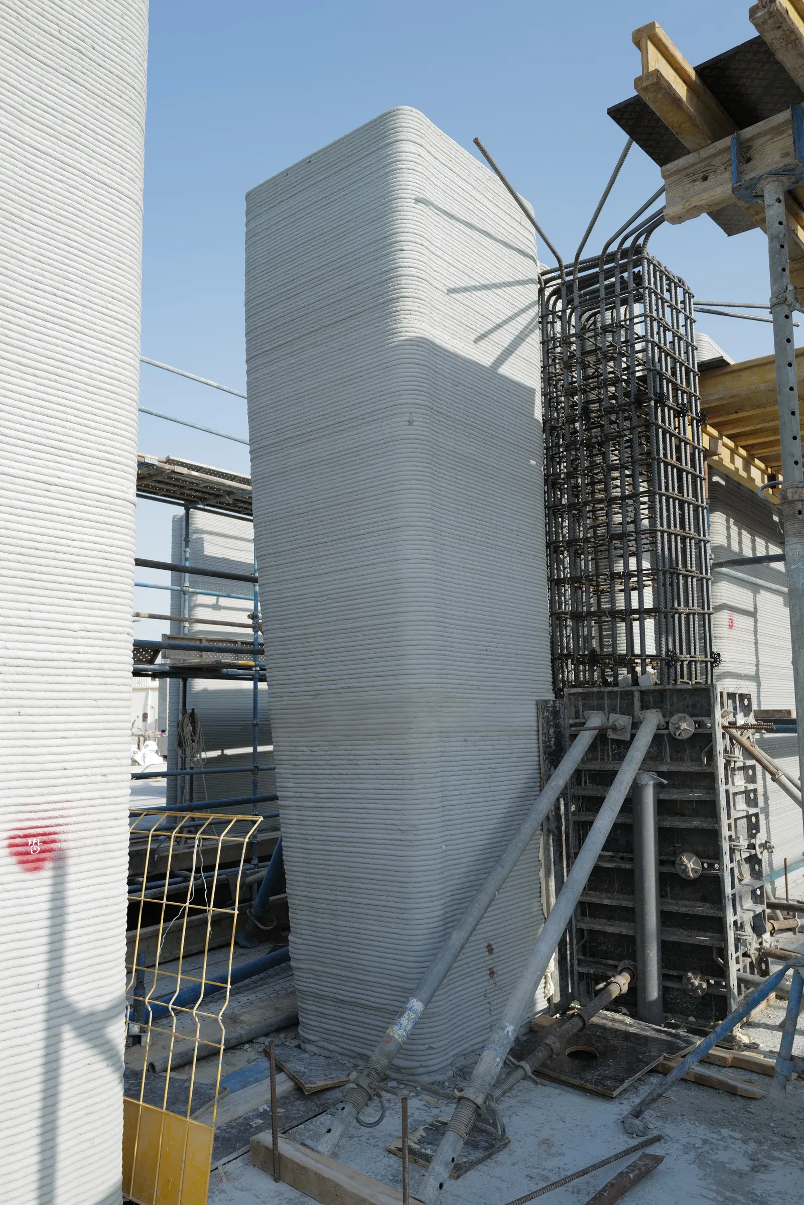 A printed column at School 08 beside a steel reinforcement cage